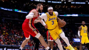 Apr 16, 2024; New Orleans, Louisiana, USA; Los Angeles Lakers forward Anthony Davis (3) dribbles against New Orleans Pelicans center Jonas Valanciunas (17) during the second half of a play-in game of the 2024 NBA playoffs at Smoothie King Center.