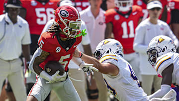 Sep 7, 2024; Athens, Georgia, USA; Georgia Bulldogs wide receiver Anthony Evans III (5) runs against Tennessee Tech Golden Eagles long snapper Turner McLaughlin (49) during the first half at Sanford Stadium. Mandatory Credit: Dale Zanine-Imagn Images