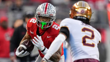 Nov 18, 2023; Columbus, Ohio, USA; Ohio State Buckeyes wide receiver Emeka Egbuka (2) runs toward Minnesota Golden Gophers defensive back Tre'Von Jones (2) after making a catch during the NCAA football game at Ohio Stadium.