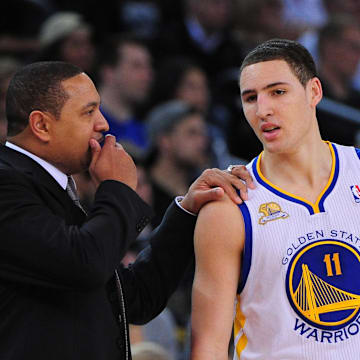 March 27, 2012; Oakland, CA, USA; Golden State Warriors head coach Mark Jackson (left) instructs guard Klay Thompson (11) during the second quarter against the Los Angeles Lakers at ORACLE Arena. Mandatory Credit: Kyle Terada-Imagn Images