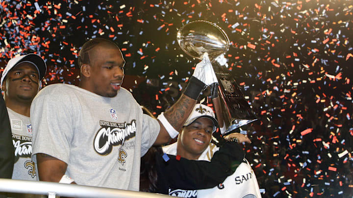 Feb 7, 2010; Miami, FL, USA; New Orleans Saints cornerback Tracy Porter (22) celebrates with the Lombardi Trophy after defeating the Indianapolis Colts 31-17 in Super Bowl XLIV at Sun Life Stadium. Mandatory Credit: Matthew Emmons-Imagn Images