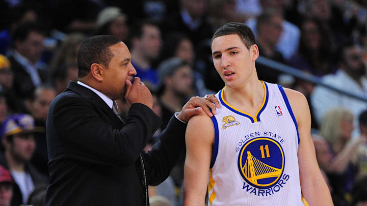 March 27, 2012; Oakland, CA, USA; Golden State Warriors head coach Mark Jackson (left) instructs guard Klay Thompson (11) during the second quarter against the Los Angeles Lakers at ORACLE Arena. Mandatory Credit: Kyle Terada-Imagn Images