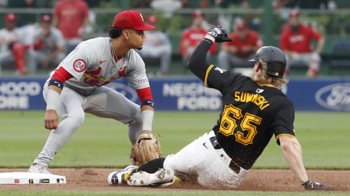 Jul 23, 2024; Pittsburgh, Pennsylvania, USA;  Pittsburgh Pirates center fielder Jack Suwinski (65) arrives safely at second base with a double as St. Louis Cardinals shortstop Masyn Winn (0) takes a throw during the fifth inning at PNC Park. Mandatory Credit: Charles LeClaire-USA TODAY Sports