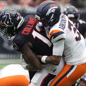 Nov 2, 2025; Houston, Texas, USA; Denver Broncos cornerback Kris Abrams-Draine (31) tackles Houston Texans wide receiver Nico Collins (12) during the first half at NRG Stadium. Mandatory Credit: Thomas Shea-Imagn Images