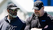 Detroit Lions general manager Brad Holmes, left, talks to head coach Dan Campbell as they walk off the field 