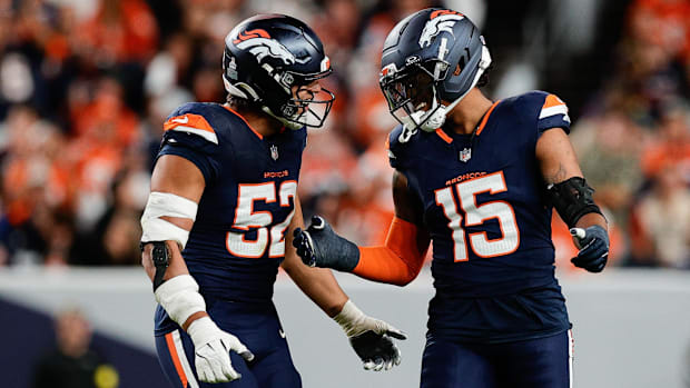 Denver Broncos linebacker Nik Bonitto (15) celebrates with Jonah Elliss (52). 