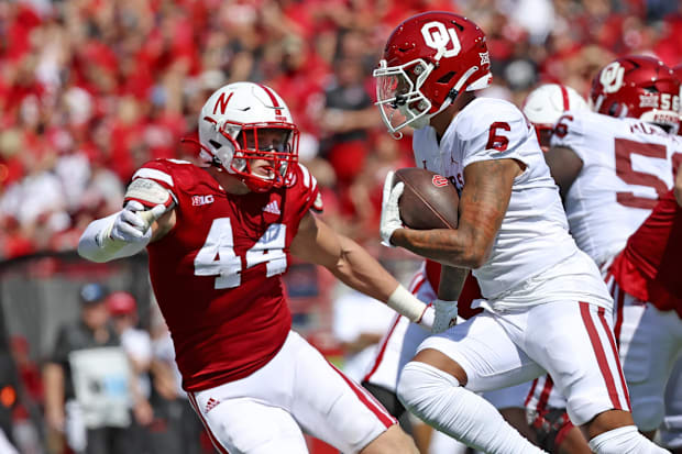 Oklahoma wide receiver LV Bunkley-Shelton carries the ball as Nebraska's Garrett Nelson pursues.