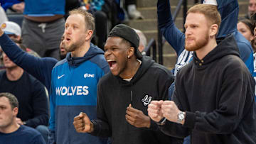 Feb 8, 2025; Minneapolis, Minnesota, USA; Minnesota Timberwolves guard Anthony Edwards (5) cheers from the bench with teammates guard Donte DiVincenzo (0) and guard Joe Ingles (7) in the fourth quarter against the Portland Trail Blazers at Target Center. Mandatory Credit: Matt Blewett-Imagn Images