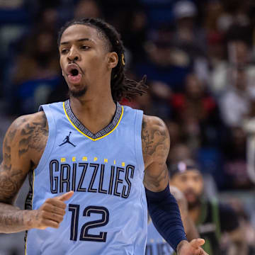 Dec 26, 2023; New Orleans, Louisiana, USA; Memphis Grizzlies guard Ja Morant (12) reacts to a made basket against the New Orleans Pelicans during the first half at Smoothie King Center. Mandatory Credit: Stephen Lew-Imagn Images