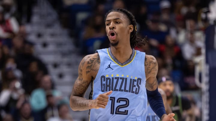 Dec 26, 2023; New Orleans, Louisiana, USA; Memphis Grizzlies guard Ja Morant (12) reacts to a made basket against the New Orleans Pelicans during the first half at Smoothie King Center. Mandatory Credit: Stephen Lew-USA TODAY Sports