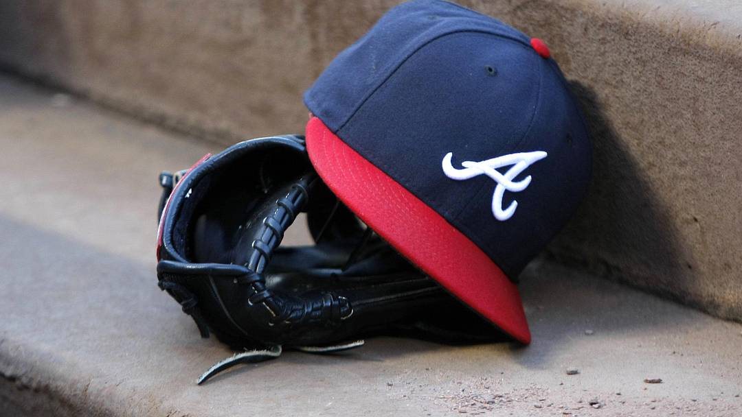 Aug 25, 2015; Atlanta, GA, USA; Detailed view of Atlanta Braves hat and glove in the dugout before a game against the Colorado Rockies at Turner Field. Mandatory Credit: Brett Davis-Imagn Images
