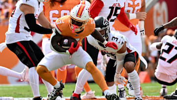 Oct 27, 2024; Tampa, Florida, USA; Tampa Bay Buccaneers running back Bucky Irving (7) runs the ball  in the first quarter against the Atlanta Falcons at Raymond James Stadium. Mandatory Credit: Jonathan Dyer-Imagn Images