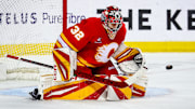 Apr 15, 2025; Calgary, Alberta, CAN; Calgary Flames goaltender Dustin Wolf (32) makes a save against the Vegas Golden Knights during the third period at Scotiabank Saddledome. Mandatory Credit: Sergei Belski-Imagn Images
