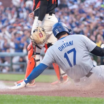 Jun 29, 2024; San Francisco, California, USA; Los Angeles Dodgers two-way player Shohei Ohtani (17) slides into home plate during the eleventh inning against the San Francisco Giants at Oracle Park.