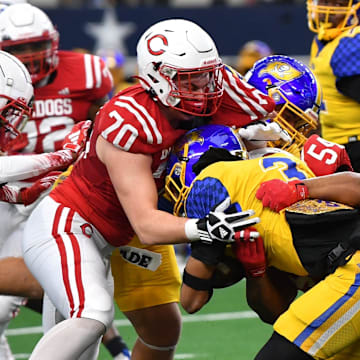 Carthage's Colt Hodges (70) and Jaydon Lewis (5) tackle Waco La Vega's Elbert Jones during the 4A DII UIL Texas State Football Championship game on Friday, December 20, 2024 at AT&T Stadium in Arlington.