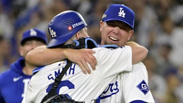 Oct 20, 2024; Los Angeles, California, USA; Los Angeles Dodgers pitcher Blake Treinen (49) celebrates with catcher Will Smith (16) after the final out to defeat the New York Mets in game six of the NLCS for the 2024 MLB playoffs at Dodger Stadium. 