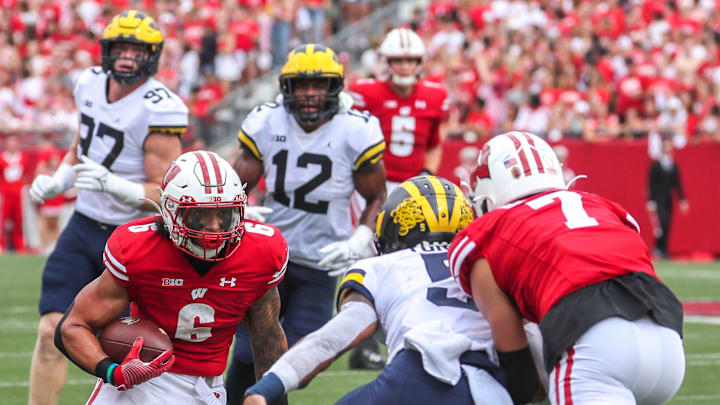 Wisconsin Badgers running back Chez Mellusi (6) runs the ball as Michigan Wolverines defensive back DJ Turner (5) guards him during their game Saturday, Oct. 2, 2021, at Camp Randall Stadium in Madison, Wis. Wisconsin Badgers running back Chez Mellusi (6) runs the ball as Michigan Wolverines defensive back DJ Turner (5) guards him during their game Saturday, Oct. 2, 2021, at Camp Randall Stadium in Madison, Wis.
