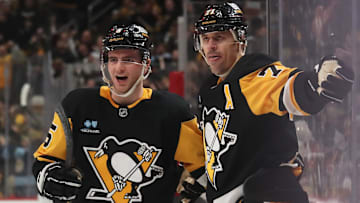 Feb 27, 2025; Pittsburgh, Pennsylvania, USA;  Pittsburgh Penguins defenseman Ryan Shea (5) and center Evgeni Malkin (71) celebrate a goal by Malkin  against  the Philadelphia Flyers during the third period at PPG Paints Arena. Mandatory Credit: Charles LeClaire-Imagn Images