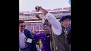 LSU interim head coach Frank Wilson raises his hands in the air after earning his first coaching victory for the Tigers.
