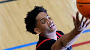 July 18, 2024; North Augusta, S.C., USA; A photographer's flash goes off as Kiyan Anthony, son of NBA star Carmelo Anthony, warms up before the Team Melo and Georgia Stars game at the Nike Peach Jam at Riverview Park Activities Center. The Georgia Stars won 64-63. Mandatory Credit: Katie Goodale-USA TODAY Network
