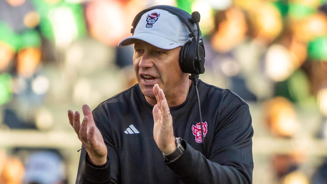 Oct 11, 2025; South Bend, Indiana, USA; NC State Wolfpack head coach Dave Doeren claps as he walks onto the field against the Notre Dame Fighting Irish during the second half at Notre Dame Stadium. Mandatory Credit: Michael Caterina-Imagn Images