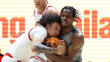 Mar 4, 2025; Salt Lake City, Utah, USA; Utah Utes guard Miro Little (1) and West Virginia Mountaineers guard Toby Okani (5) battle for the ball during the first half at Jon M. Huntsman Center. Mandatory Credit: Rob Gray-Imagn Images