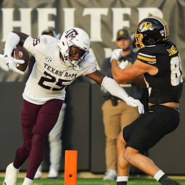 Nov 8, 2025; Columbia, Missouri, USA; Texas A&M Aggies safety Dalton Brooks (25) returns a fumble against Missouri Tigers tight end Jude James (89) during the first half at Faurot Field at Memorial Stadium. Mandatory Credit: Jay Biggerstaff-Imagn Images