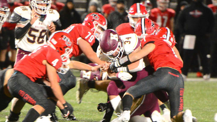 Killingly senior Soren Rief is surrounded New Canaan defenders during the Class L quarterfinals Tuesday at Dunning Field.