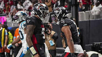Jan 5, 2025; Atlanta, Georgia, USA; Atlanta Falcons running back Bijan Robinson (7) reacts with quarterback Michael Penix Jr. (9) after running for a touchdown against the Carolina Panthers during the second half at Mercedes-Benz Stadium. Mandatory Credit: Dale Zanine-Imagn Images