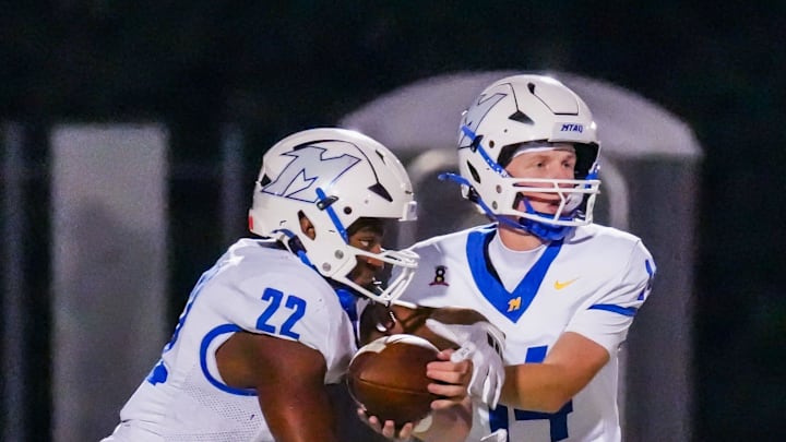 Mukwonago's Jerrell Anderson (22) takes a hand-off from quarterback George Molitor (14) during the football game against Oconomowoc, Sept. 12, 2025, in Oconomowoc, Wisconsin. Mukwonago won the game, 35-6. Mukwonago's Jerrell Anderson (22) takes a hand-off from quarterback George Molitor (14) during the football game against Oconomowoc, Sept. 12, 2025, in Oconomowoc, Wisconsin. Mukwonago won the game, 35-6.