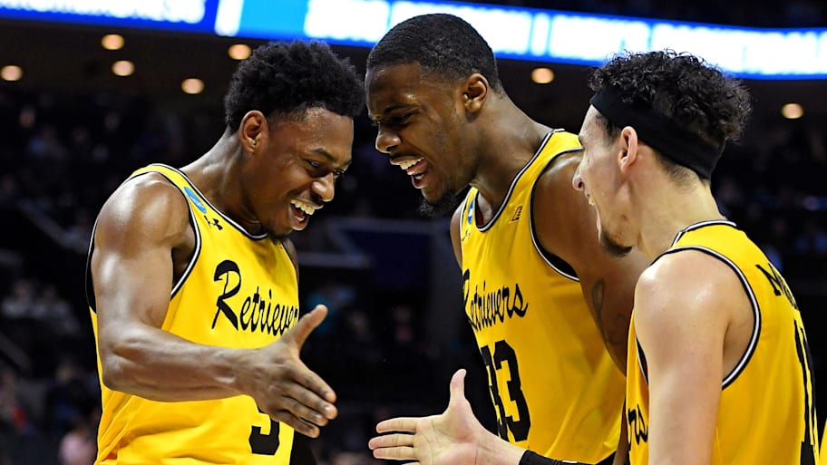 UMBC Retrievers guard Jourdan Grant celebrates with guard K.J. Maura and forward Arkel Lamar against Virginia.