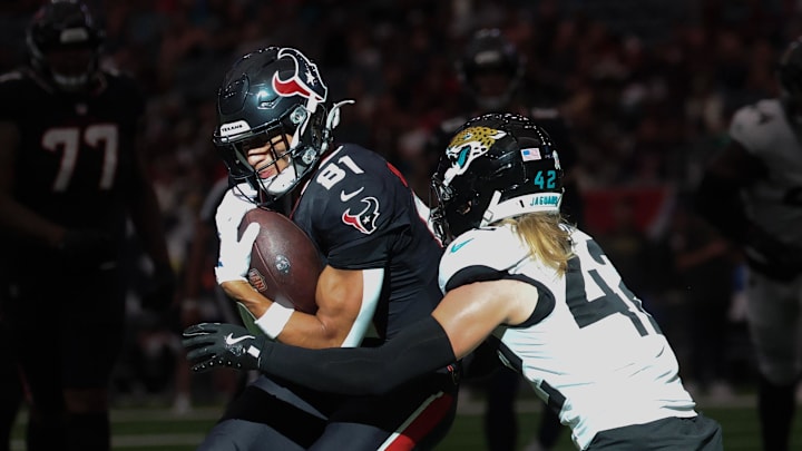 Nov 9, 2025; Houston, Texas, USA;Houston Texans wide receiver Jayden Higgins (81) is tackled by Jacksonville Jaguars safety Andrew Wingard (42) in the second half at NRG Stadium. Mandatory Credit: Thomas Shea-Imagn Images