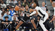 Oct 26, 2025; San Antonio, Texas, USA; Brooklyn Nets guard Cam Thomas (24) dribbles against San Antonio Spurs guard Stephon Castle (5) in the first half at Frost Bank Center. Mandatory Credit: Daniel Dunn-Imagn Images