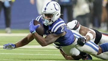 Indianapolis Colts wide receiver Josh Downs (2) is brought down by Houston Texans cornerback Myles Bryant (25) on Sunday, Nov. 30, 2025, during a game at Lucas Oil Stadium in Indianapolis.