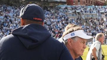 Oct 25, 2025; Chapel Hill, North Carolina, USA; North Carolina Tar Heels head coach Bill Belichick shakes Virginia Cavaliers head coach Tony Elliott hand after the Tar Heels lose to Virginia in overtime at Kenan Stadium. Mandatory Credit: Bob Donnan-Imagn Images