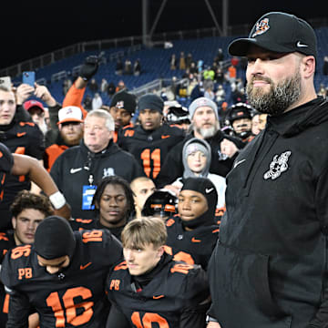 Massillon football coach NateMoore watches with his team as the OHSAA announces Massillon as the 2023 Division II state champions