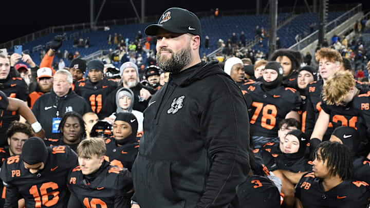 Massillon football coach NateMoore watches with his team as the OHSAA announces Massillon as the 2023 Division II state champions