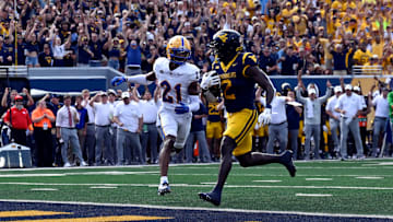 WVU running back Tye Edwards rushes for a touchdown against the Pitt Panthers during The Backyard Brawl at Milan Puskar Stadium in Morgantown, W.Va.