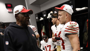 San Francisco 49ers running backs coach Bobby Turner (L) and running back Christian McCaffrey (R)