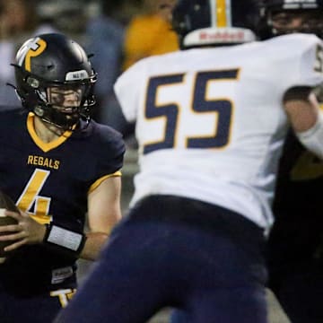 Regina’s Kyle Tracy (4) looks to pass against Cascade Friday, Sept. 27, 2024 in Iowa City, Iowa.
