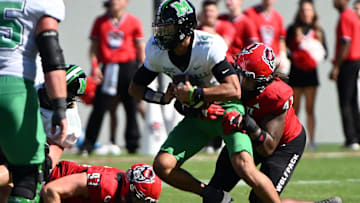 Oct 7, 2023; Raleigh, North Carolina, USA; Marshall Thundering Herd quarterback Cam Fancher (14) is sacked by North Carolina State Wolfpack defensive lineman Jykeveous Red Hibbler (47) during the first half at Carter-Finley Stadium. Mandatory Credit: Rob Kinnan-Imagn Images