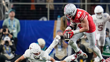 Ohio State Buckeyes defensive end Jack Sawyer (33) sacks Texas Longhorns quarterback Quinn Ewers (3) forcing a fumble during the second half of the Cotton Bowl Classic College Football Playoff semifinal game at AT&T Stadium in Arlington, Texas on Jan. 10, 2025. Sawyer returned the fumble for a touchdown, and Ohio State won 28-14.