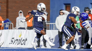 Dec 23, 2023; Boise, ID, USA; Utah State Aggies running back Davon Booth (6) runs for a touchdown during the first half against the Georgia State Panthers at Albertsons Stadium.  Mandatory Credit: Brian Losness-USA TODAY Sports

