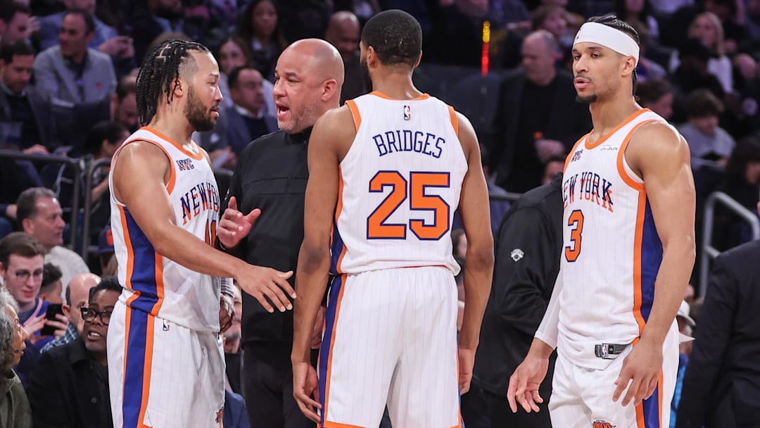 Feb 8, 2025; New York, New York, USA;  New York Knicks assistant coach Rick Brunson talks with New York Knicks guard Jalen Brunson (11), forward Mikal Bridges (25), and guard Josh Hart (3) during a timeout in the third quarter against the Boston Celtics at Madison Square Garden. Mandatory Credit: Wendell Cruz-Imagn Images