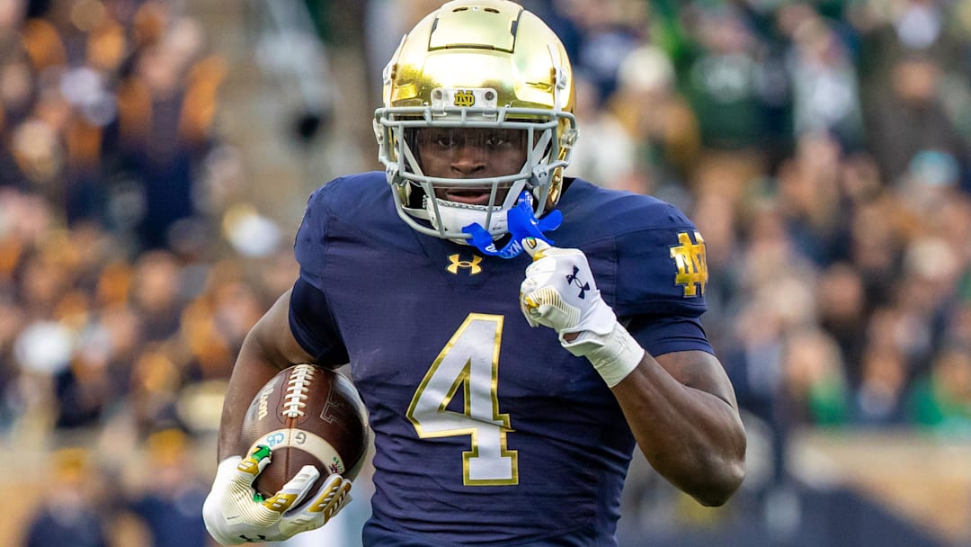 Nov 22, 2025; South Bend, Indiana, USA; Notre Dame Fighting Irish running back Jeremiyah Love (4) runs the ball against the Syracuse Orange during the first half at Notre Dame Stadium. Mandatory Credit: Michael Caterina-Imagn Images