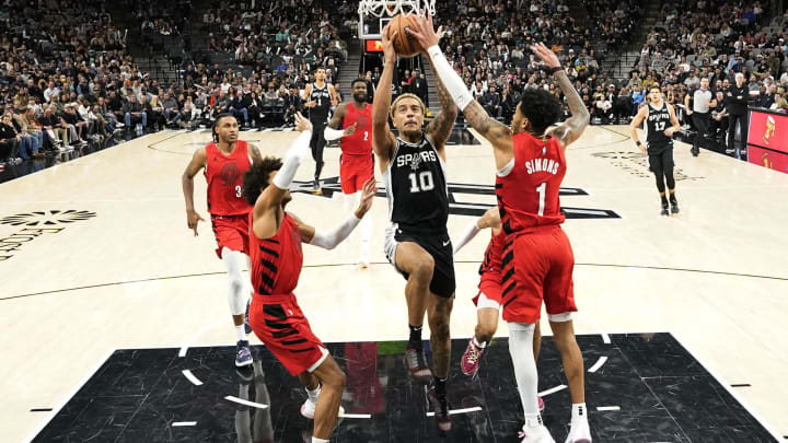 Jan 26, 2024; San Antonio, Texas, USA; San Antonio Spurs forward Jeremy Sochan (10) drives to the basket between Portland Trail Blazers guards Matisse Thybulle (4) and Anfernee Simons (1) during the second half at Frost Bank Center. Mandatory Credit: Scott Wachter-USA TODAY Sports