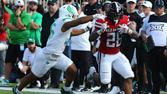 Sep 14, 2024; Lubbock, Texas, USA; Texas Tech Red Raiders running back Tahj Brooks (28) is tackled by North Texas Mean Green defensive back Jaylen Smith (36) in the first half at Jones AT&T Stadium and Cody Campbell Field. Mandatory Credit: Michael C. Johnson-Imagn Images