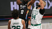 Jun 1, 2021; Brooklyn, New York, USA; Brooklyn Nets shooting guard James Harden (13) looks to pass against Boston Celtics point guard Marcus Smart (36) and shooting guard Evan Fournier (94) and center Tristan Thompson (13) during the fourth quarter of game five of the first round of the 2021 NBA Playoffs at Barclays Center. Mandatory Credit: Brad Penner-Imagn Images