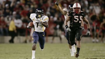 Sept 13, 2007; College Park, MD, USA; West Virginia running back Noel Devine (7) carries the ball for a 76 yard gain Maryland linebacker Trey Covington (55) gives chase in the third quarter at Chevy Chase Bank Field at Byrd Stadium.  West Virginia defeated Maryland 31-14. Mandatory Credit: James Lang-Imagn Images Copyright © James Lang