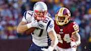 Dec 11, 2011; Landover, MD, USA; New England Patriots tight end Rob Gronkowski (87) runs with the ball past Washington Redskins strong safety DeJon Gomes (24) in the first quarter at FedEx Field. Mandatory Credit: Geoff Burke-Imagn Images